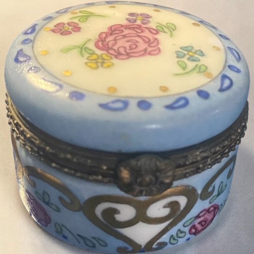 Vintage decorative trinket box  hand-painted floral motifs and gold accents.